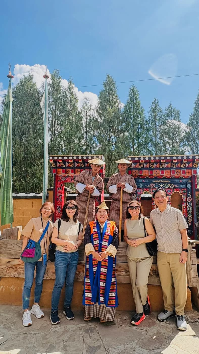 Guests gathered beside a Bhutanese gateway