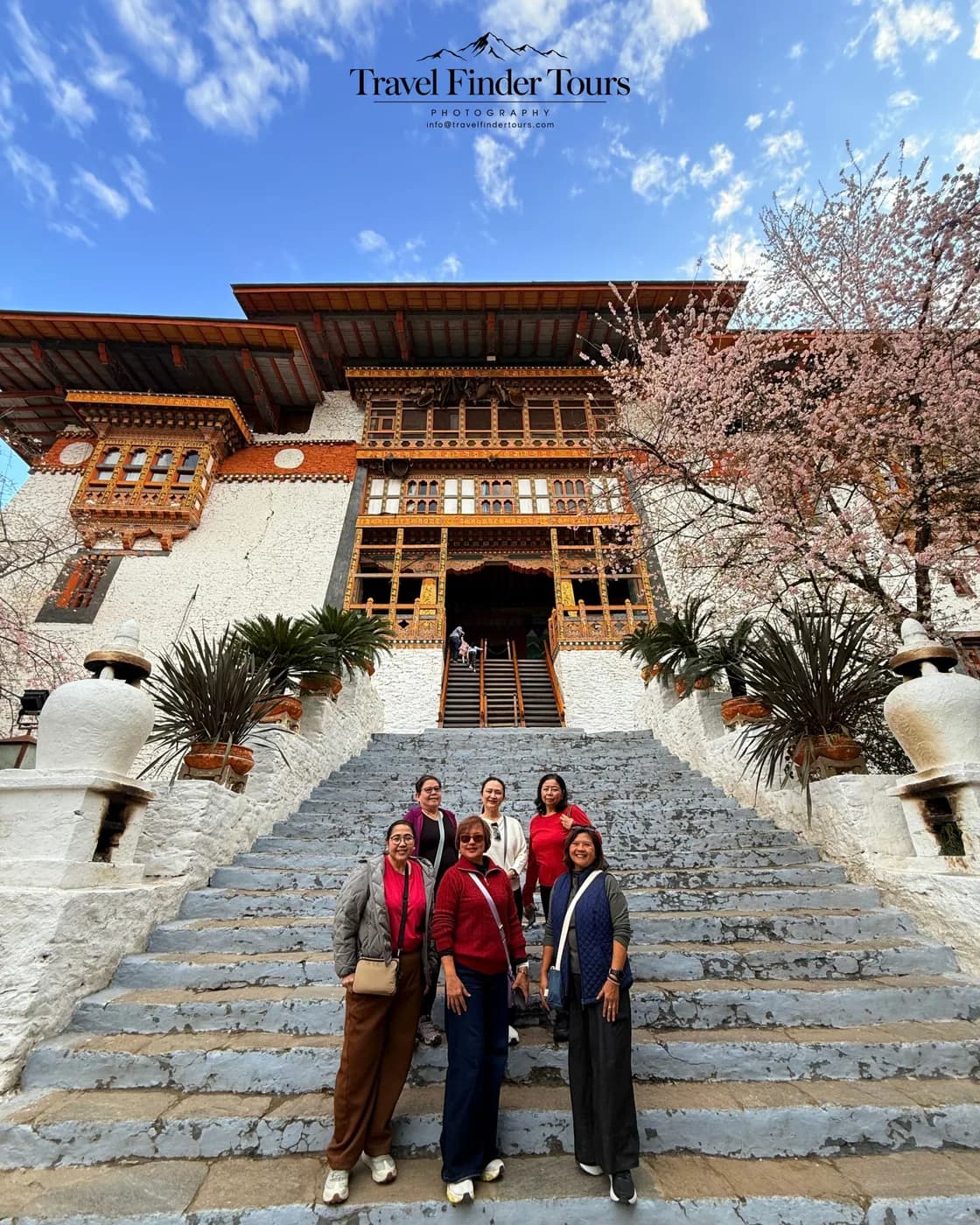 Guests climbing the steps of a Bhutanese monastery