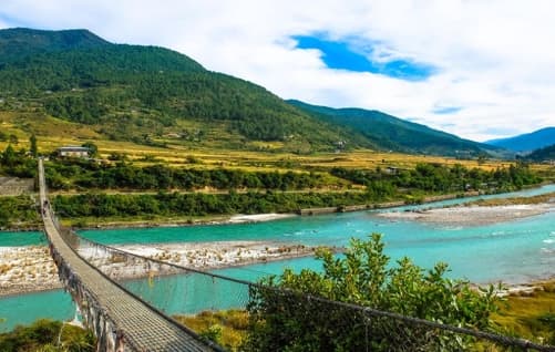 Bhutan valley landscape with a suspension bridge